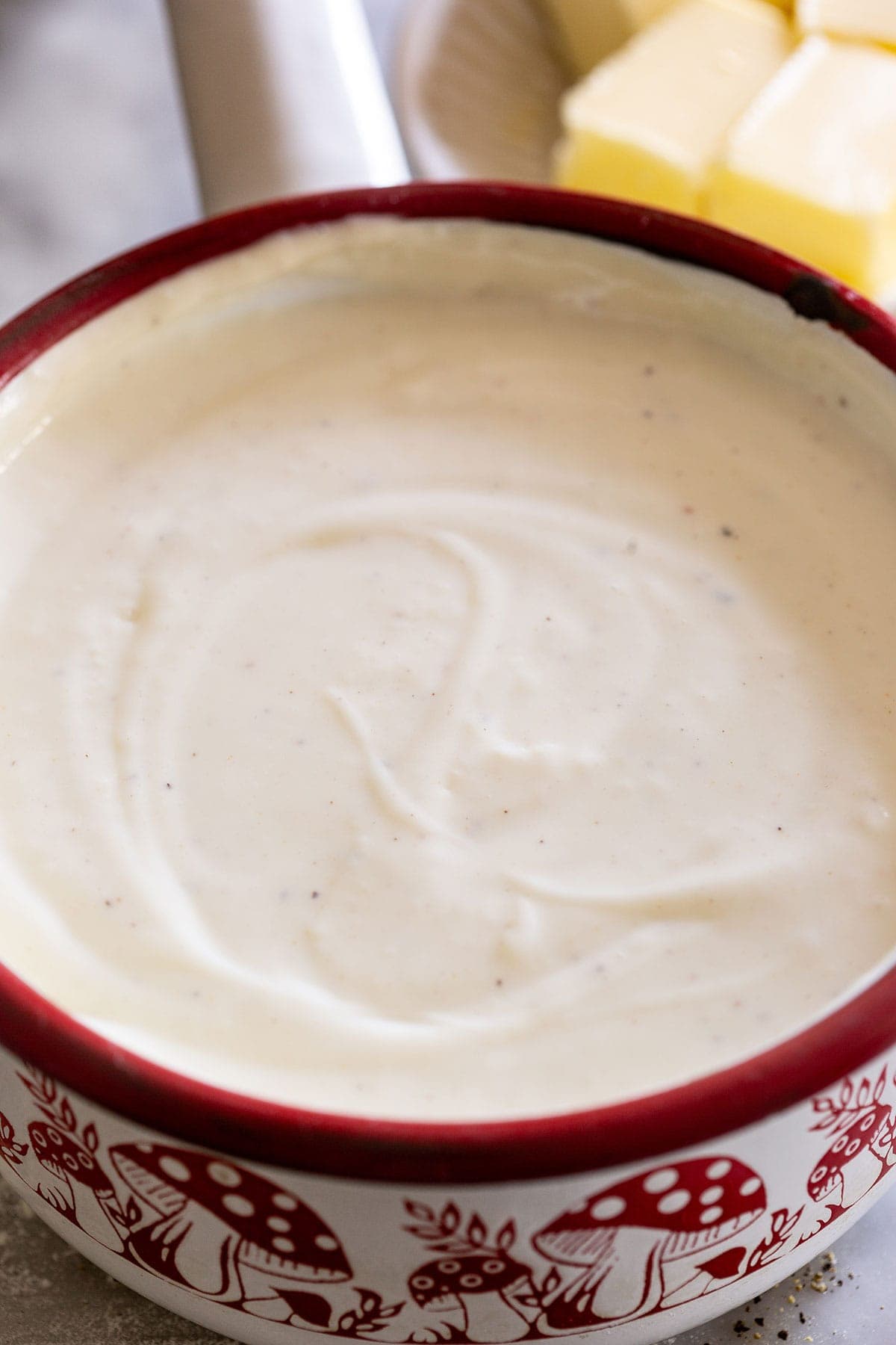 Besciamella sauce in a small pot.