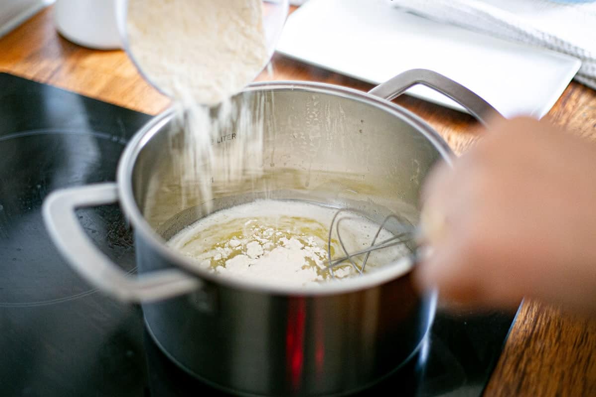 Adding the flour to the pot.