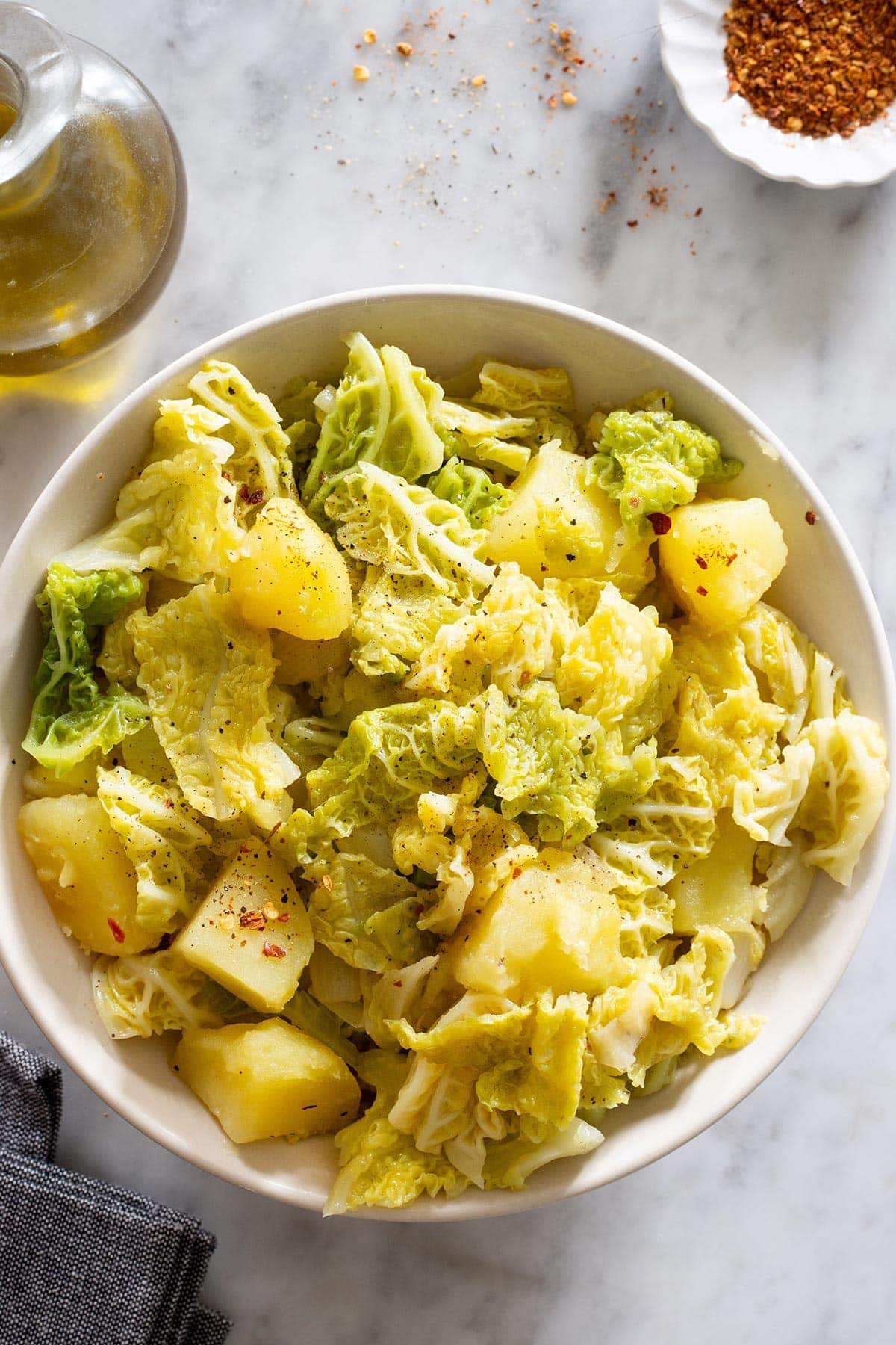 Verza e patate, an Italian cabbage and potato side dish displayed in a bowl.