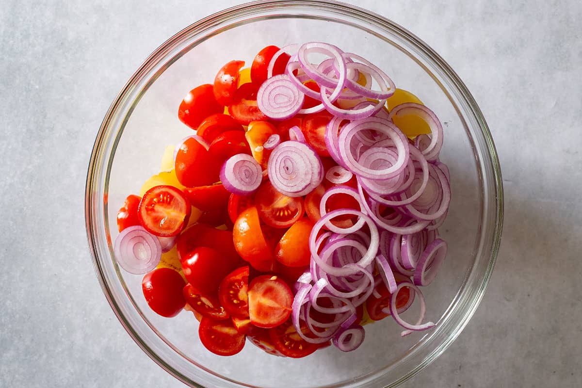 A bowl of sliced tomatoes and onions.