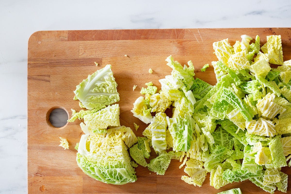 Chopped savoy cabbage on a cutting board.