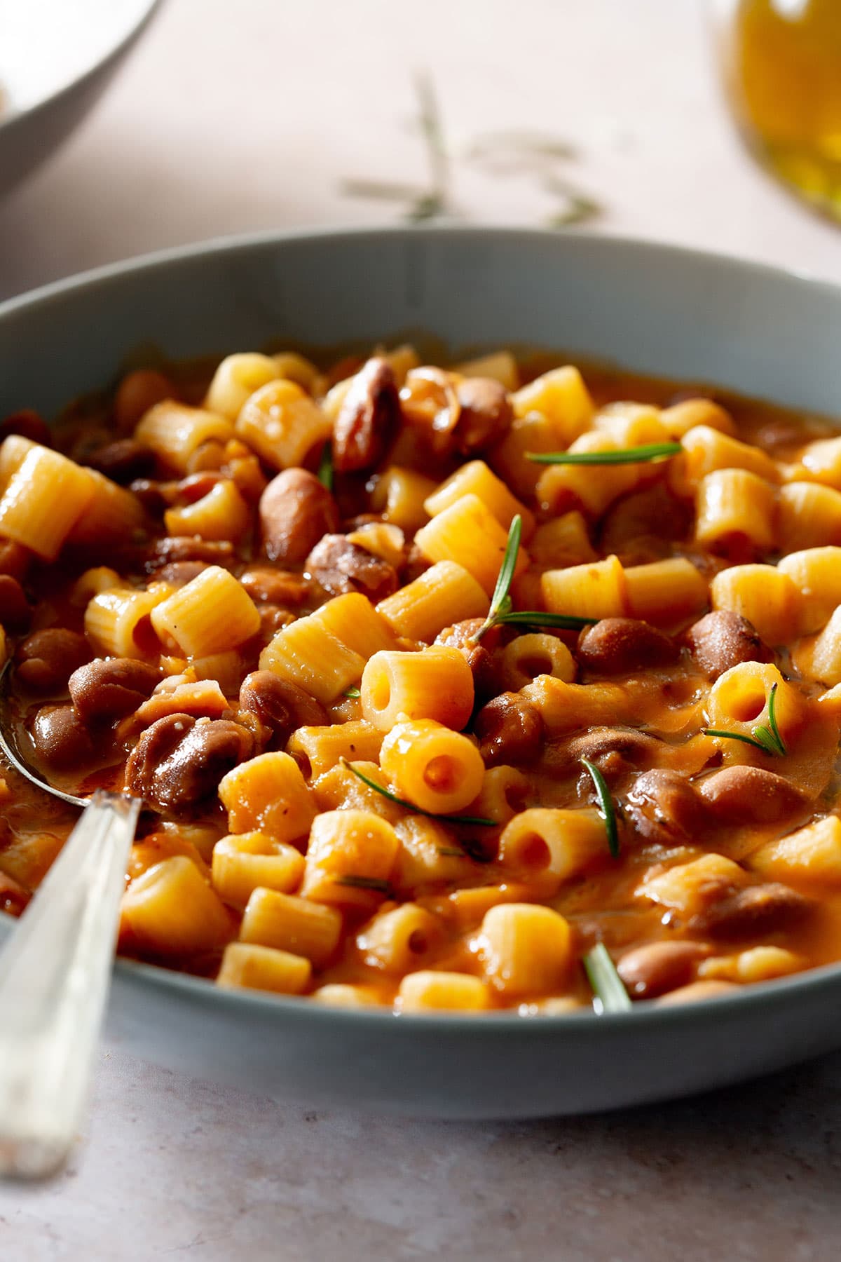 Creamy pasta e fagioli in a bowl with a spoon.
