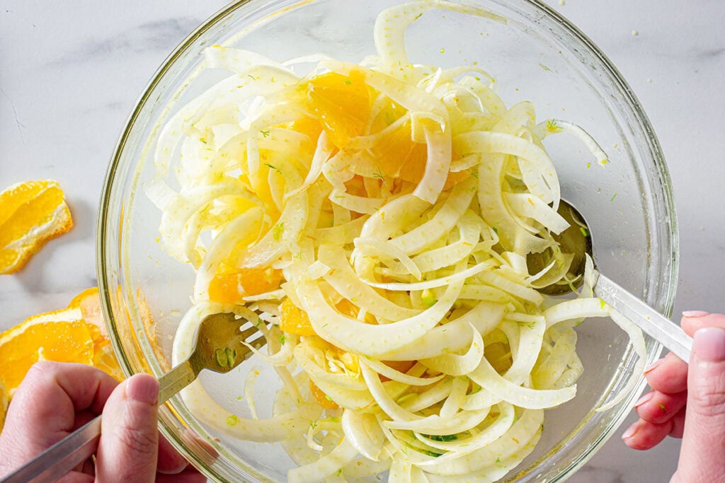 Mixing the fennel and orange salad.