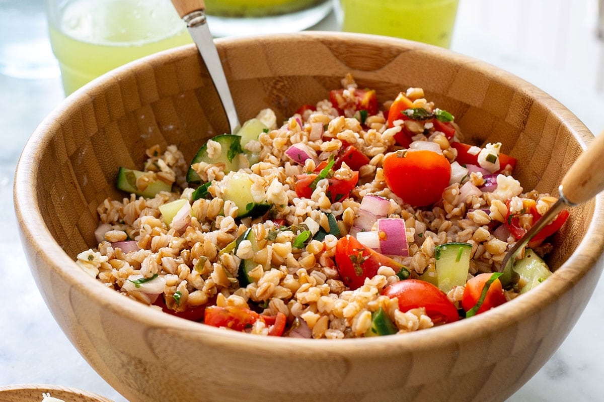 Italian farro salad (insalata di farro) in a wooden bowl.