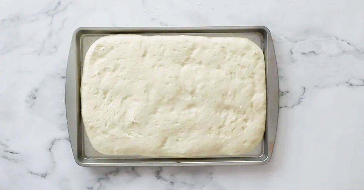The dough on a baking sheet, after proofing.
