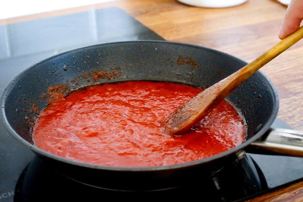 Cooking tomato sauce in a pan.