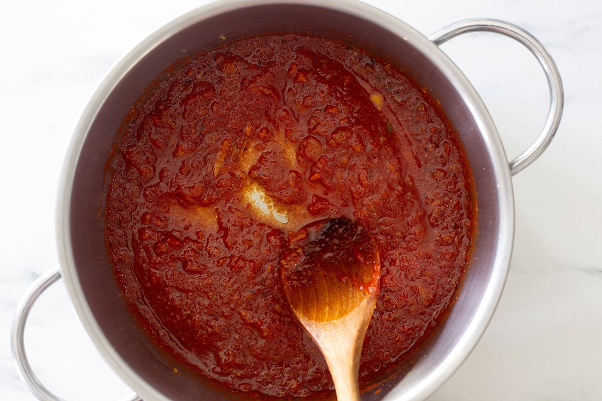 Cooking the tomato passata in a pot.