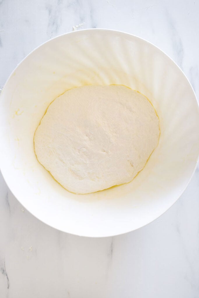 A dough ball inside a bowl.