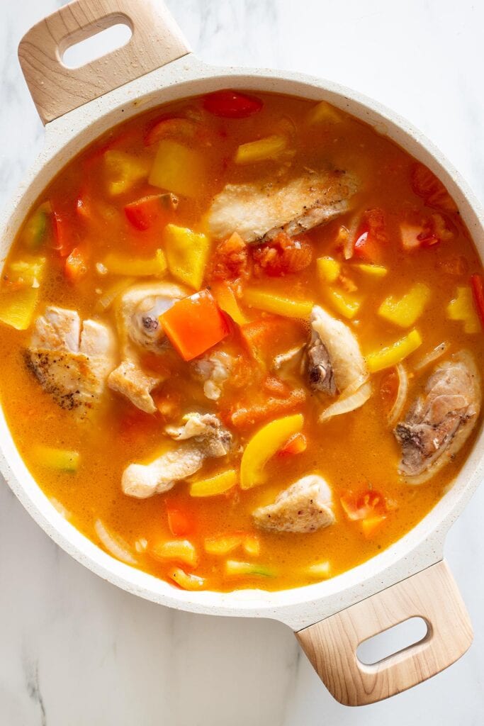 Added water to the pan with chicken and peppers.