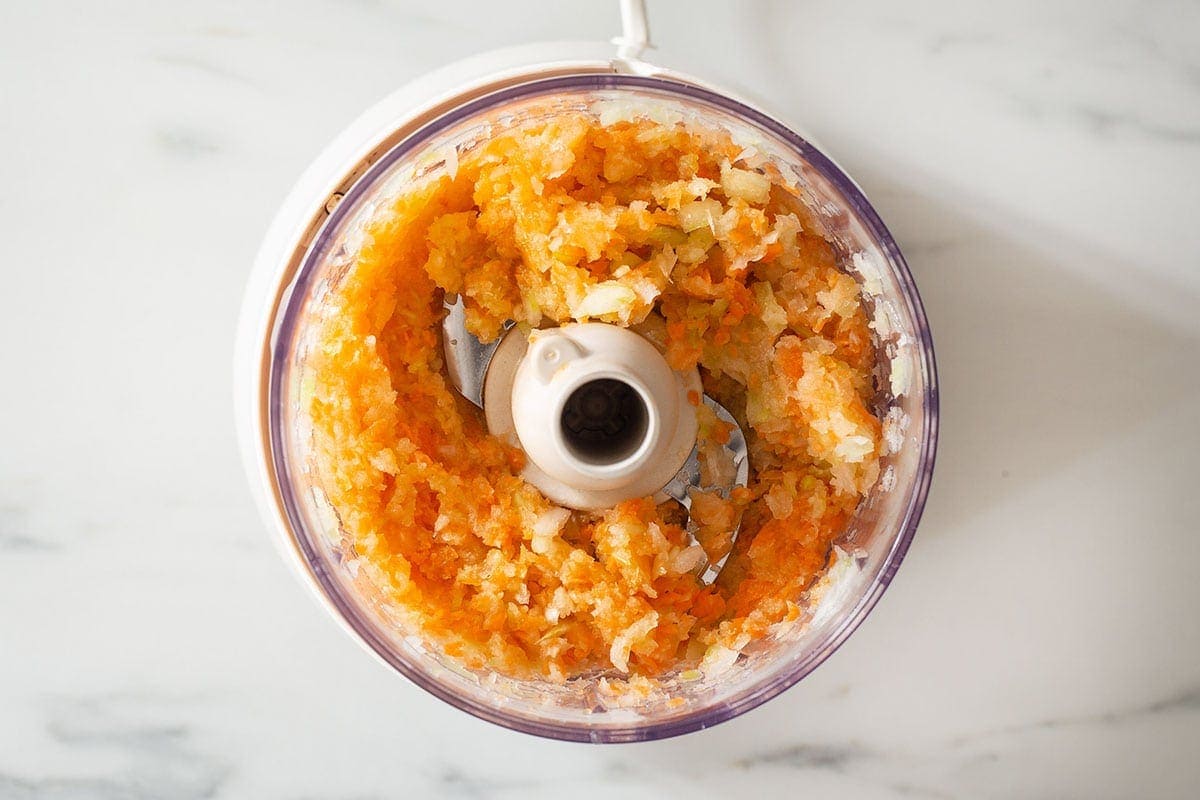 Chopped onion, carrots, and celery in a food processor. This is soffritto.