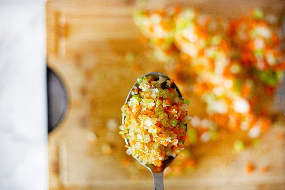 Showing finely chopped vegetables with a spoon.