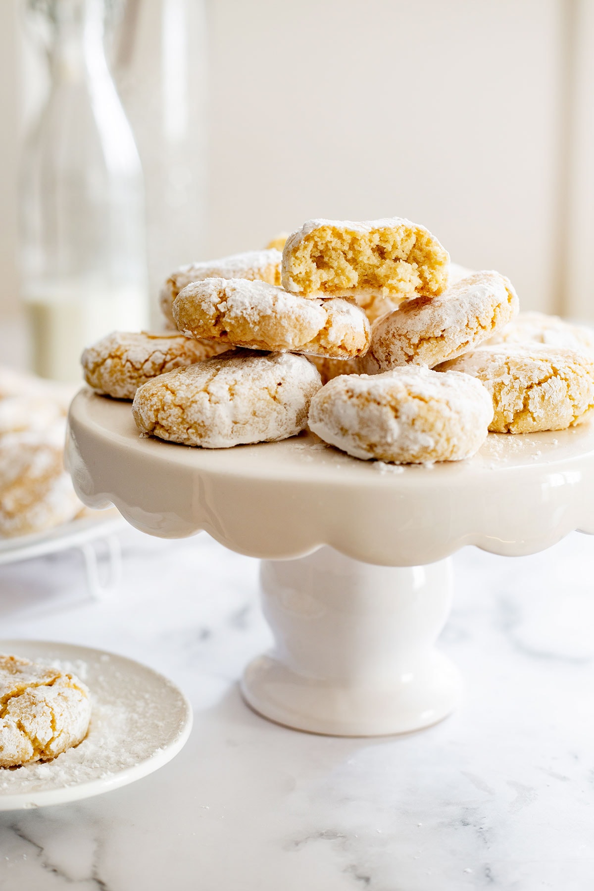 Soft amaretti morbidi cookies piled on a cake stand.