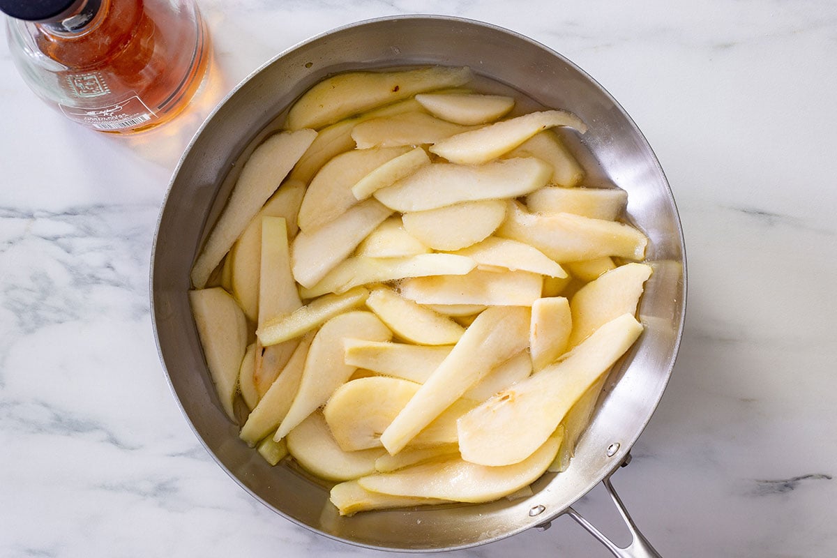 The pears cooking in a pan.