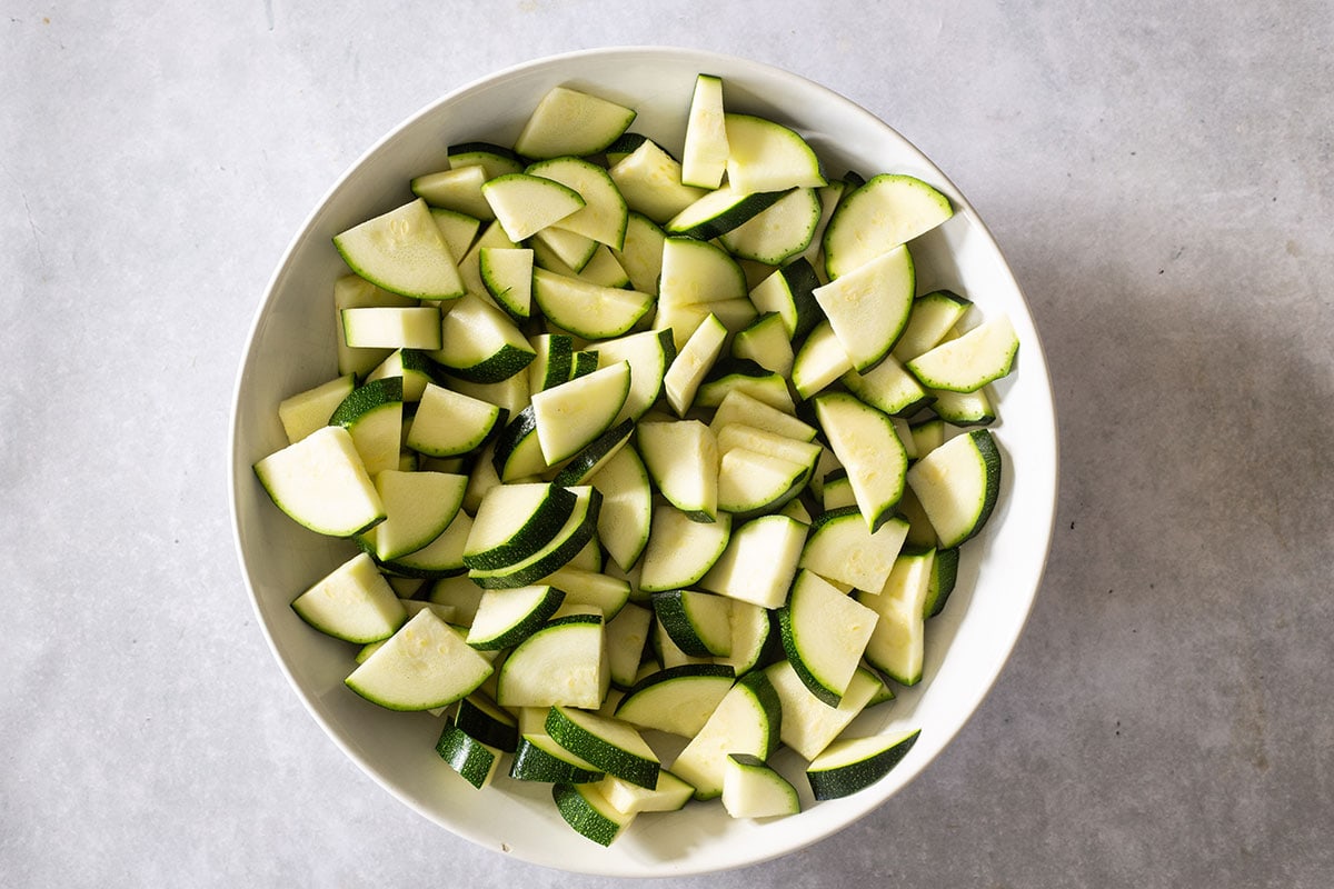 Zucchini quartered and sliced on a plate.