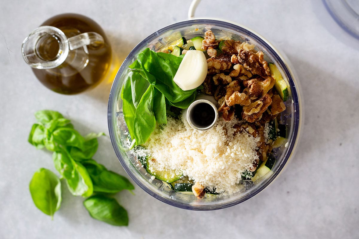 Ingredients for pesto di zucchine in a food processor.