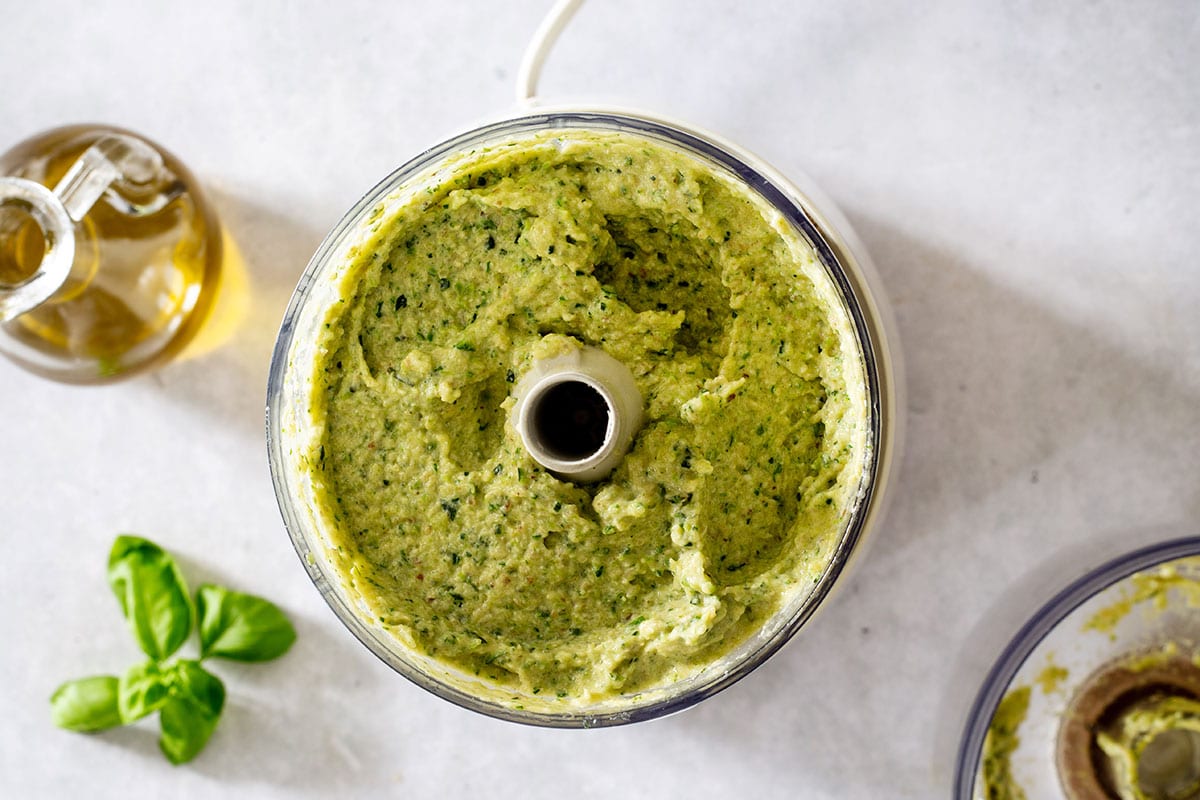 Zucchini pesto in a food processor, freshly made.