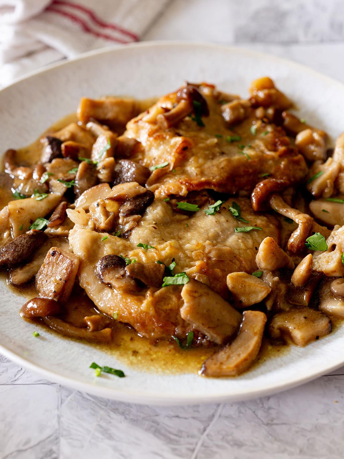 Veal scaloppine ai funghi served on a plate.