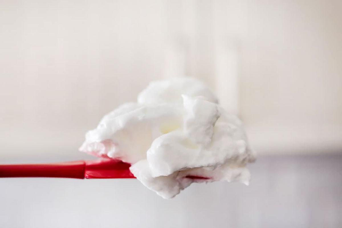 Showing fluffy egg whites with a spatula.