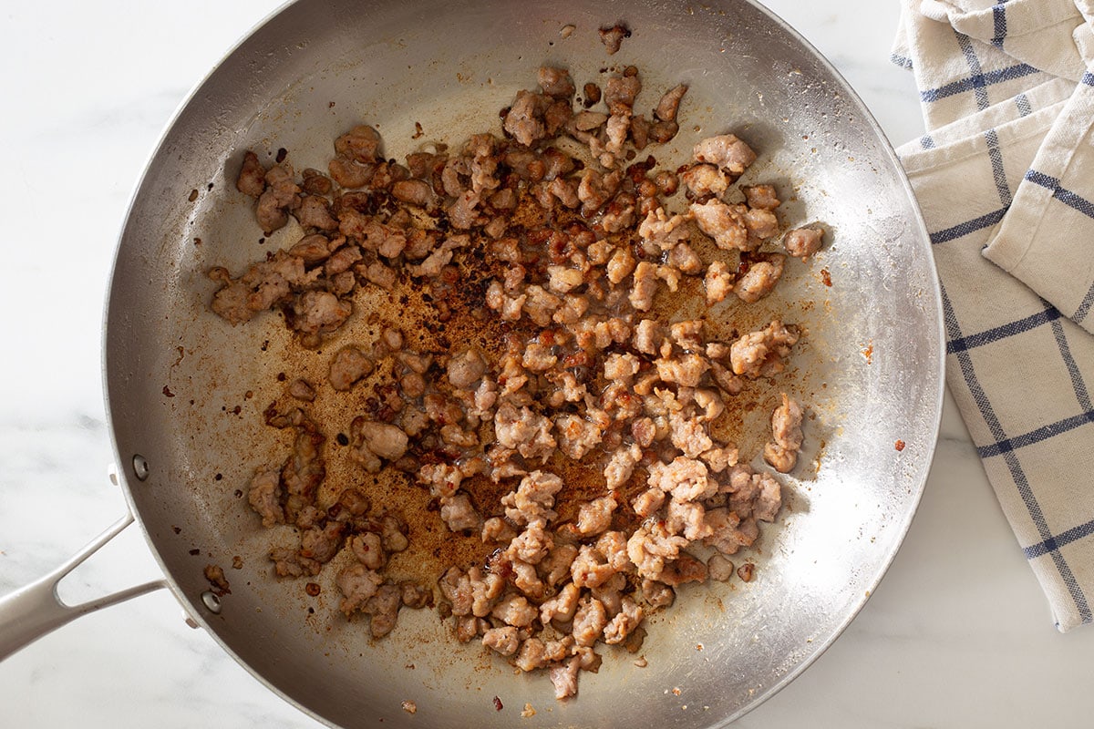 Italian sausage cooked in a pan.