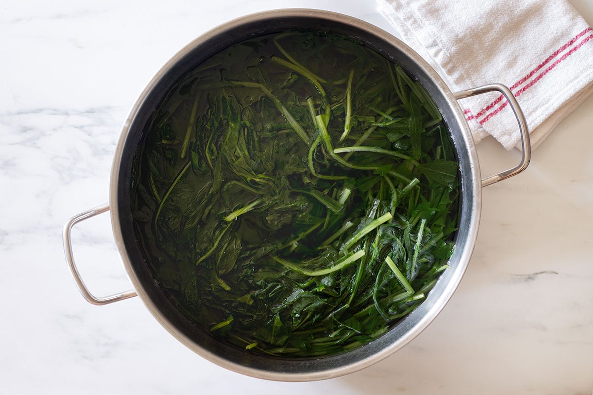 Cooked chicory in a large pot.