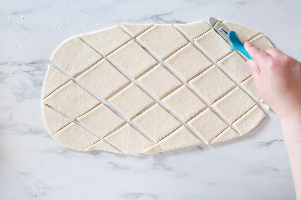 Cutting the dough into diamonds shape.