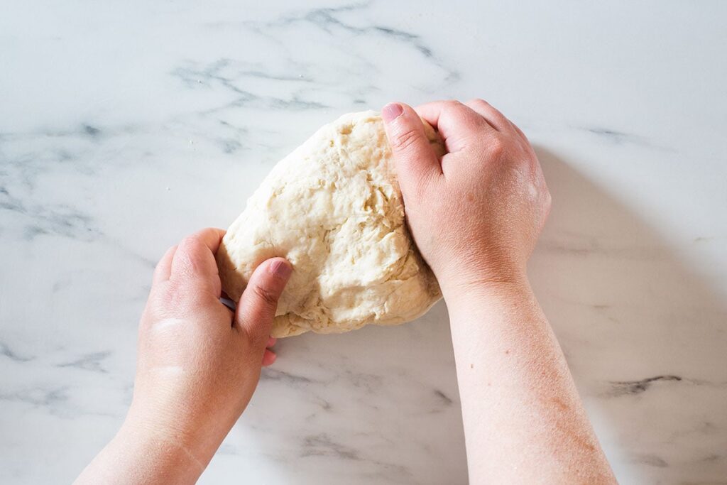 Kneading the dough with hands.