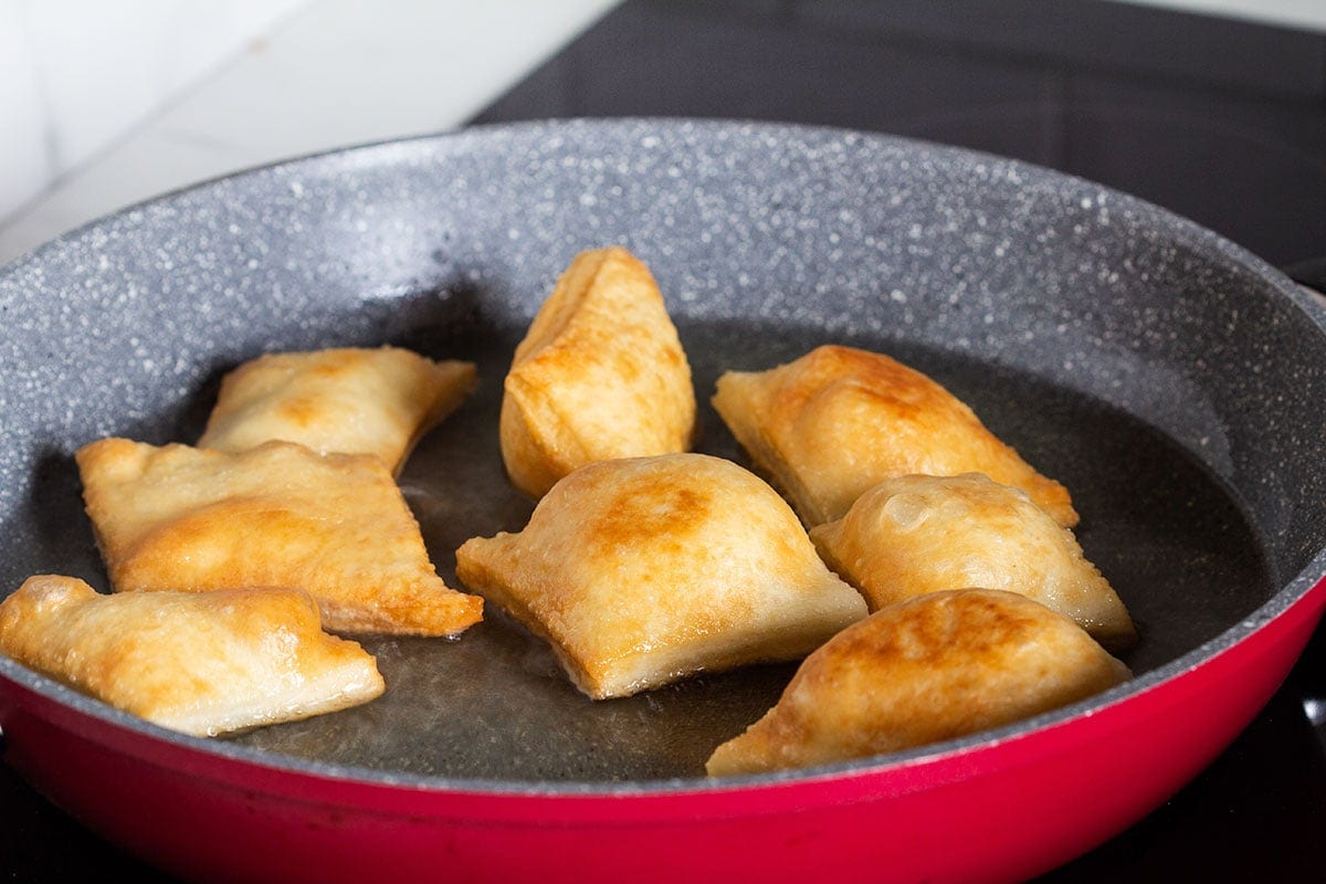 Frying the pieces of torta in a pan.