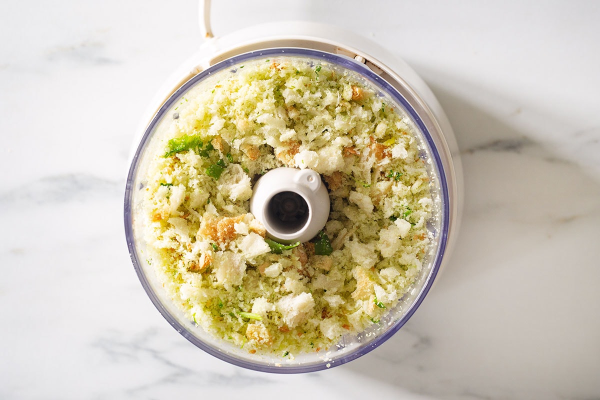 The mixture of breadcrumbs and herbs in a food processor.