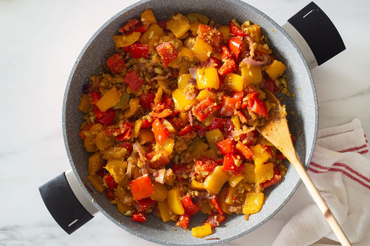 Breadcrumbs and bell peppers cooked in a pan.