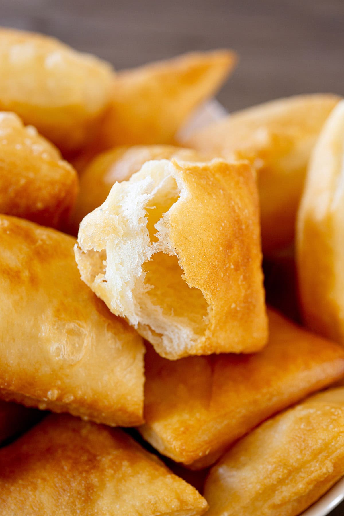 Close-up of open torta fritta to see the puffy texture inside.