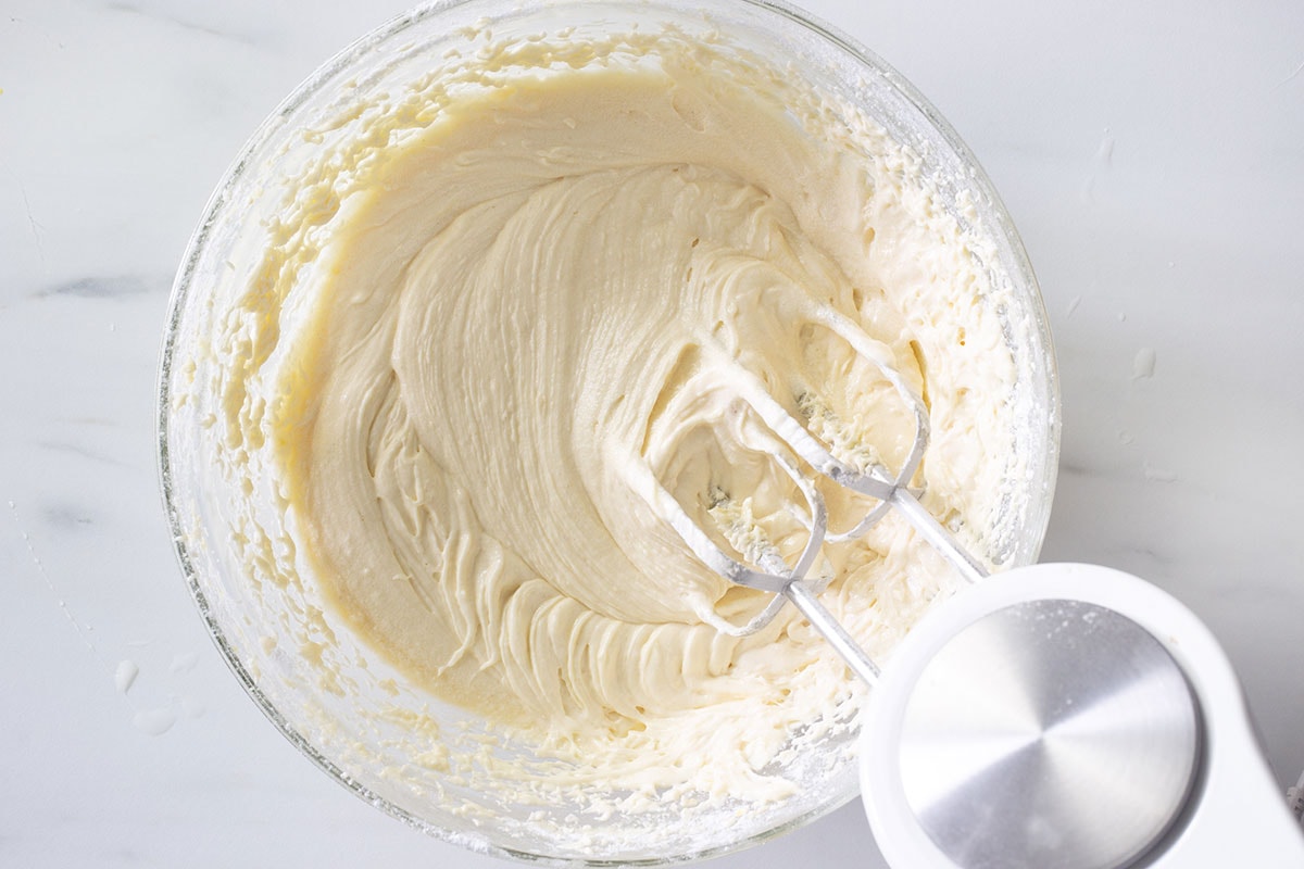 The final batter in a bowl with the electric mixer.