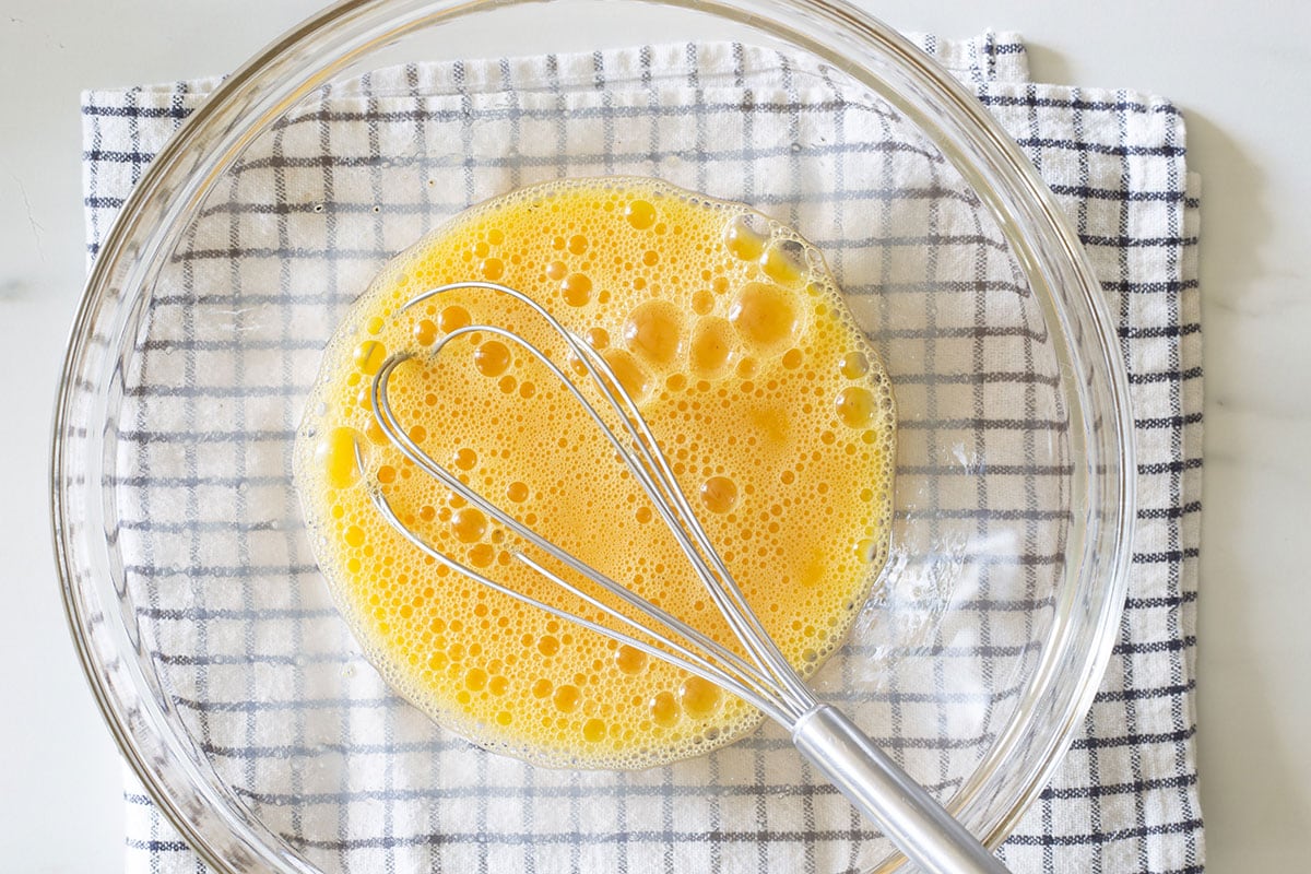 Eggs whisked in a bowl.