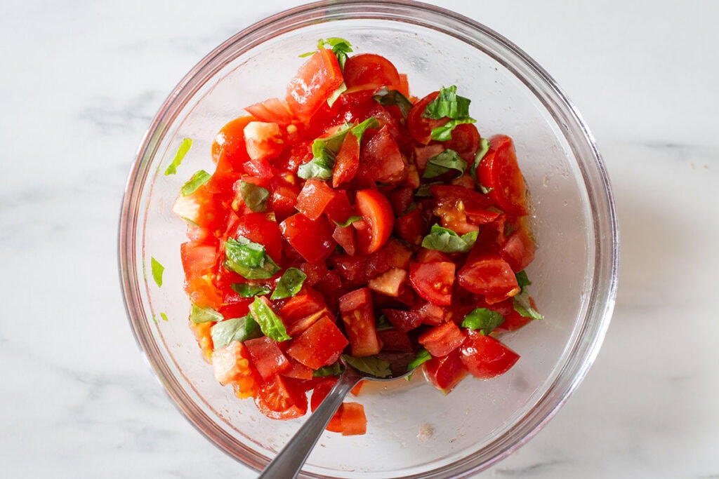 The tomato mixture for bruschetta in a bowl.