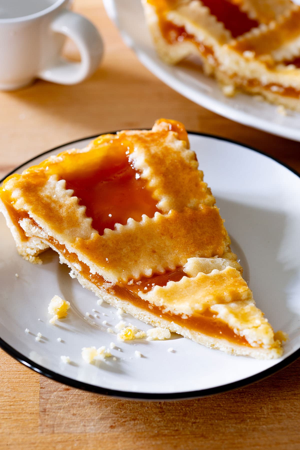 A slice of crostata di marmellata on a small plate.