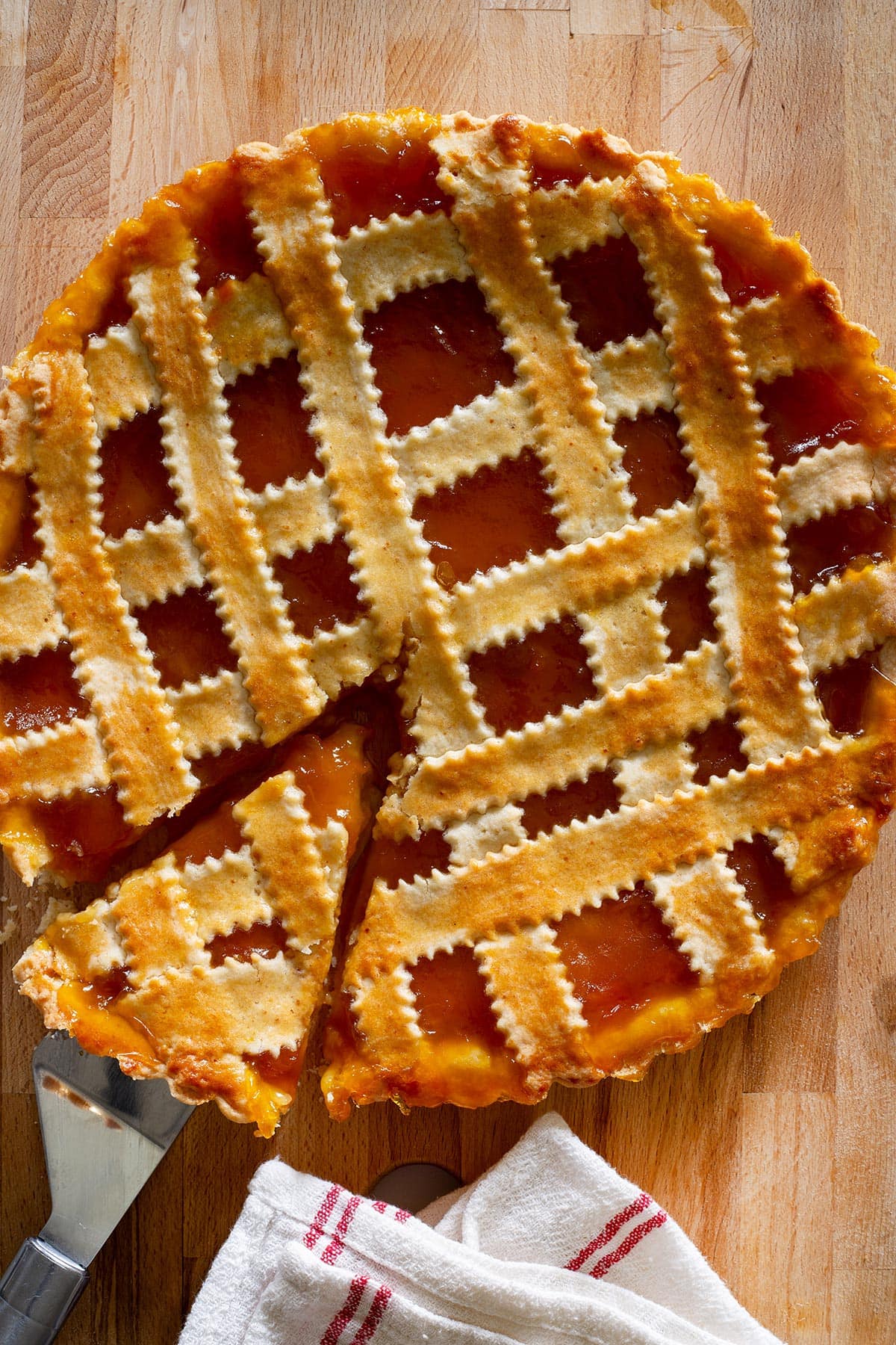 Crostata di marmellata, also known as Italian jam tart, on a rustic surface.