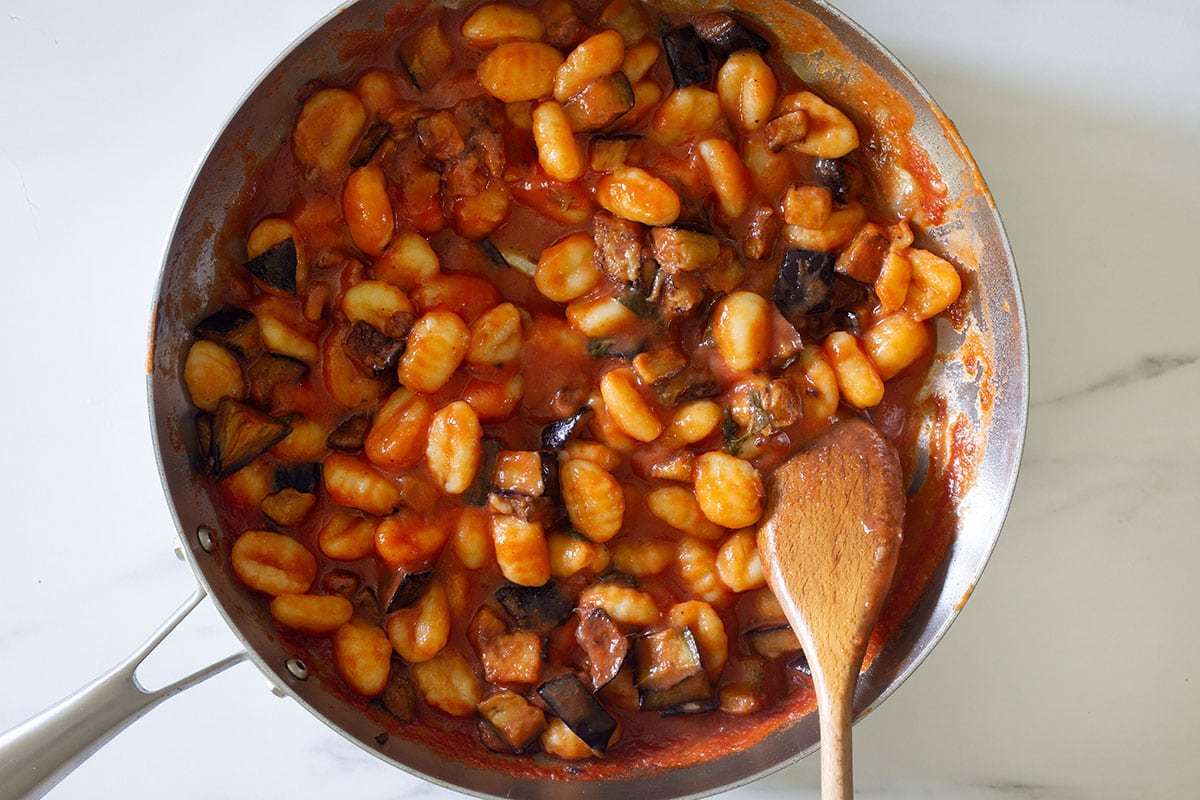 Gnocchi coated with the Norma sauce in a pan.