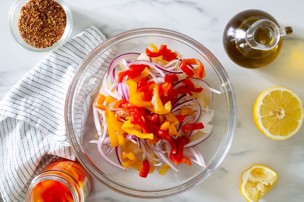 Pickled bell peppers added to the bowl.