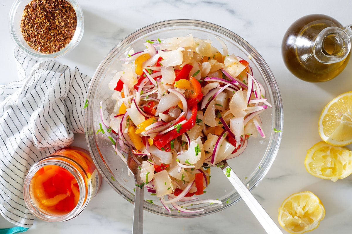 Mixed and ready insalata di nervetti in a bowl with some ingredients around.
