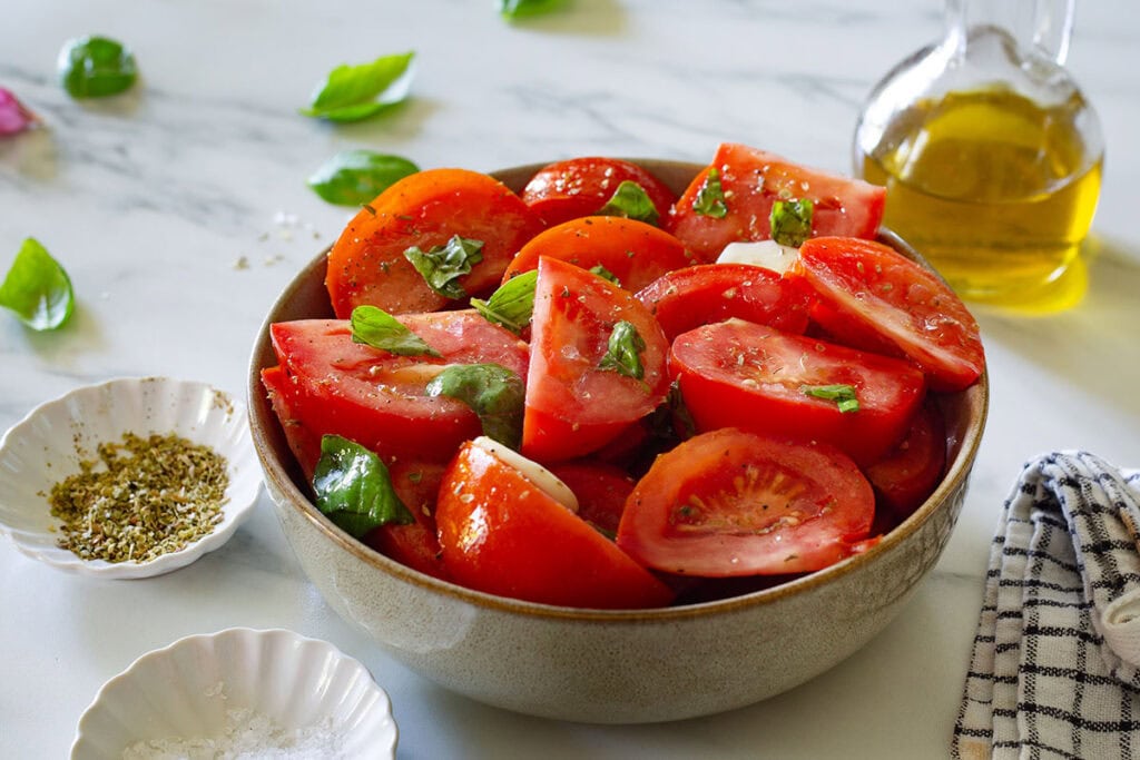 Finished insalata di pomodori in a serving bowl.