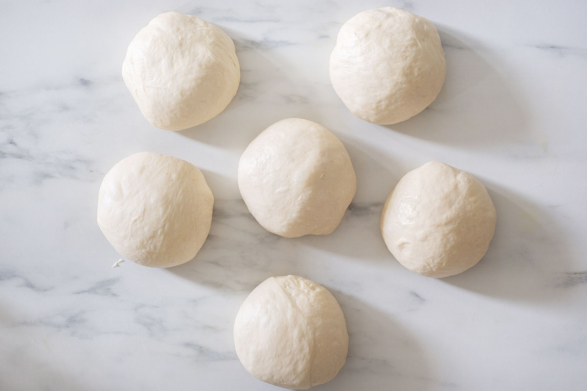 Balls of dough on a kitchen surface.
