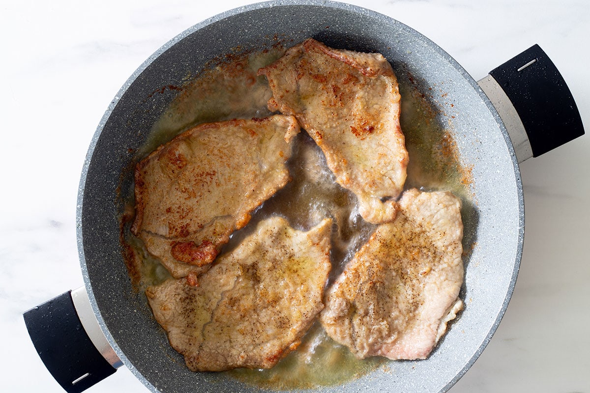 Veal slices pan frying.