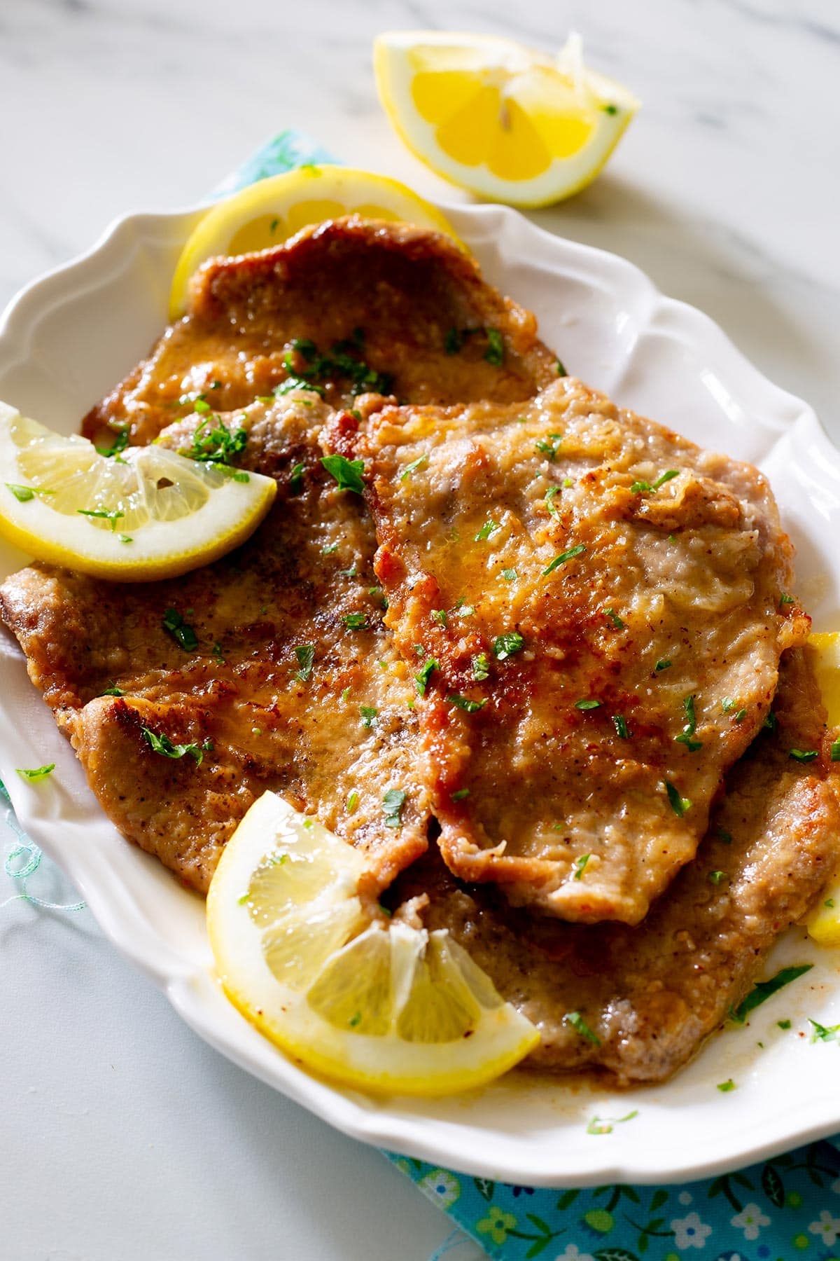 Italian scaloppine al limone on a platter.