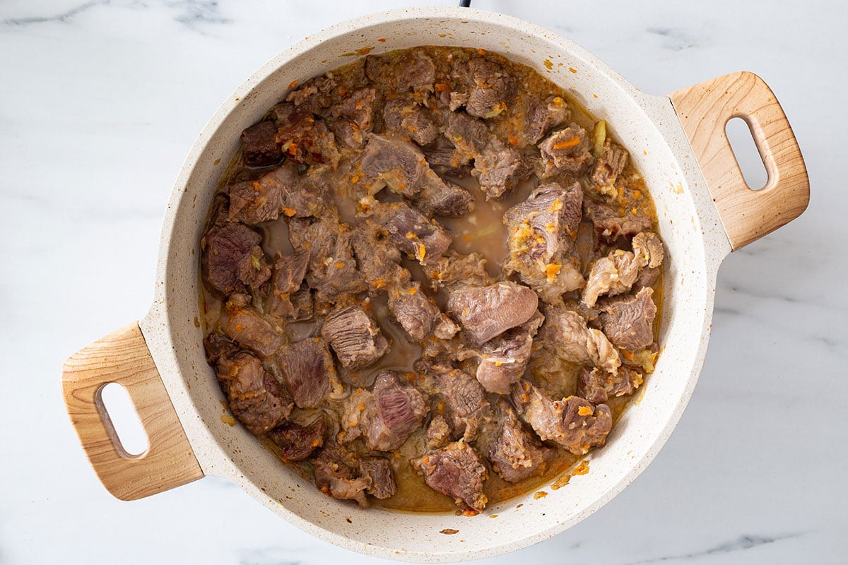 The beef chunks cooked with soffritto veggies and simmering in a bit of wine.