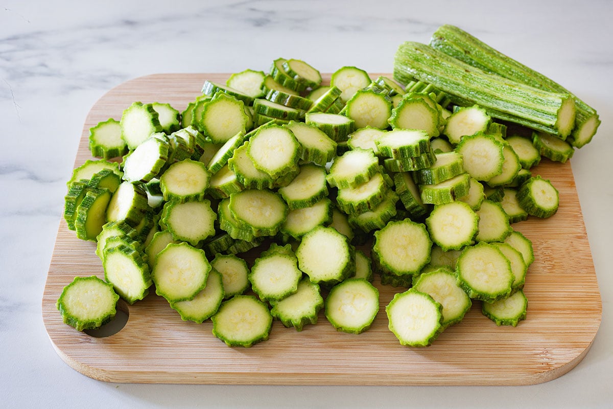 Zucchini romanesche sliced on a cutting board.
