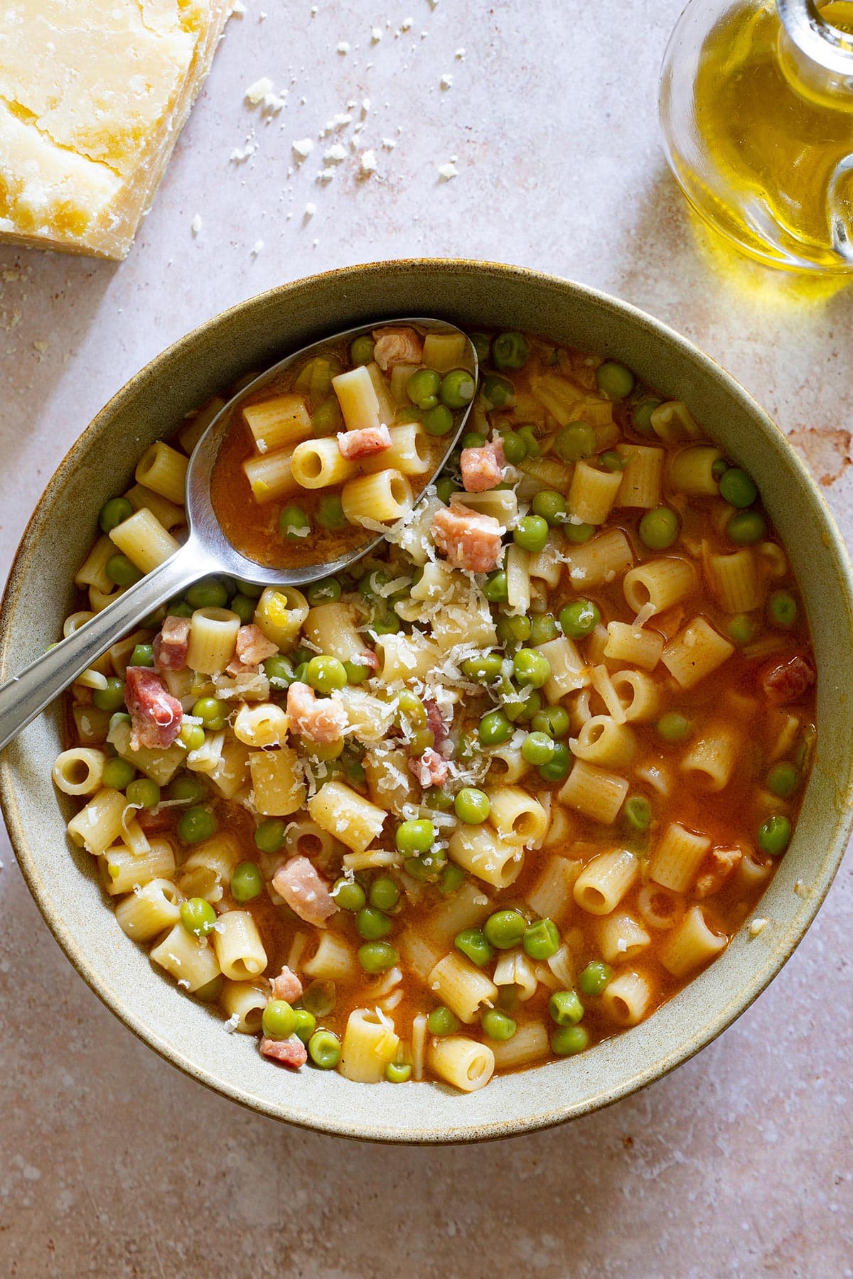 Pasta e piselli in a bowl with a spoon.