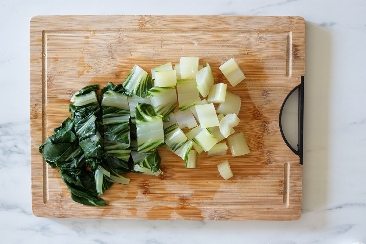 Chard, cooked and cut into chunks on a cutting board.