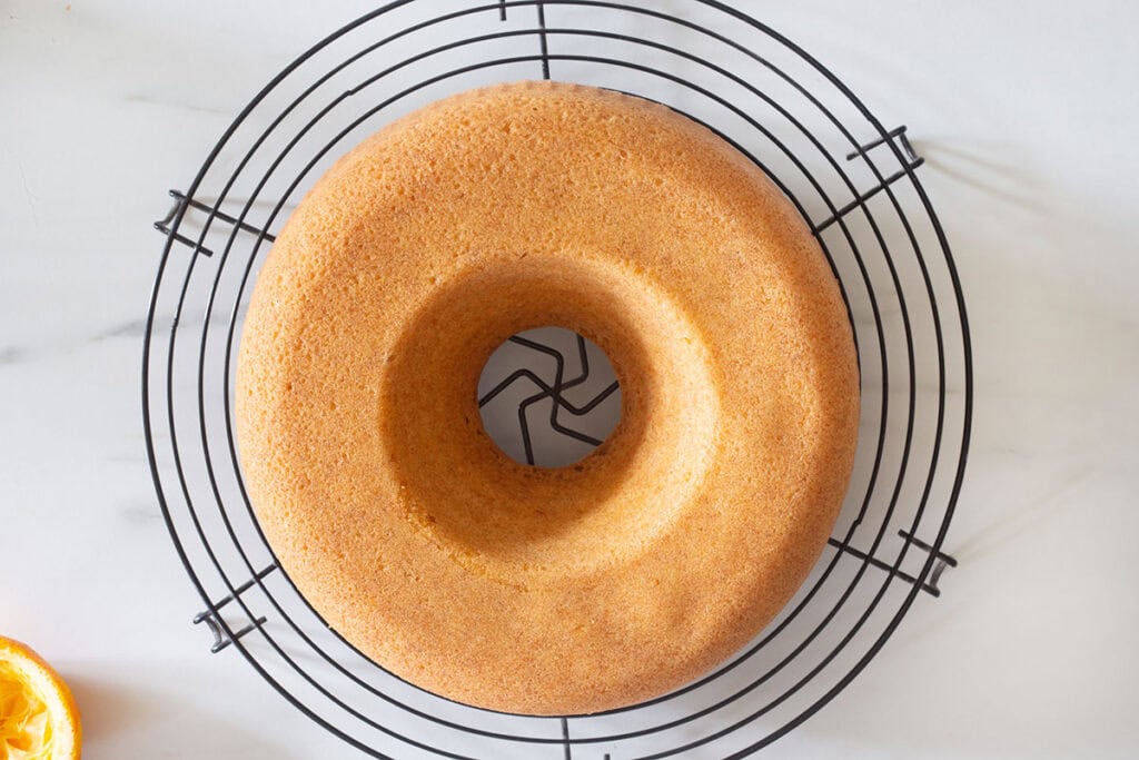 The ciambella cake on a cooling rack.